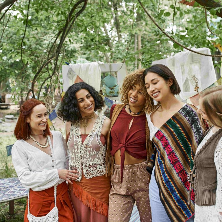 smiling african american woman hugging stylish multiethnic friends in retreat center